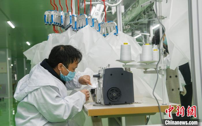 工人生產(chǎn)防護(hù)服，保障抗疫物資供應(yīng)。廣安市委宣傳部供圖